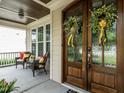 Charming front porch with elegant wooden front doors and cozy seating at 730 Toms Creek Rd, Cary, NC 27519