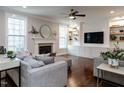 Bright living room featuring a fireplace, custom built-ins, and hardwood floors at 730 Toms Creek Rd, Cary, NC 27519