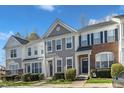 Charming townhome with well-maintained landscaping, neutral siding, and inviting front entrance at 8415 Reedy Ridge Ln, Raleigh, NC 27613