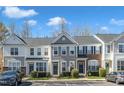 View of well-maintained townhomes, showcasing the community's convenient parking and curb appeal at 8415 Reedy Ridge Ln, Raleigh, NC 27613