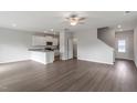Open-concept living room with modern flooring, neutral paint, and an eat-in kitchen at 903 Rhino Bnd, Oxford, NC 27565