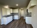 Well-equipped kitchen featuring ample storage, stainless steel appliances, gray backsplash, and wood-look flooring at 91 Lotus Ave, Smithfield, NC 27577