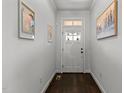 Bright foyer with dark wood floors and white walls featuring lovely artwork at 105 Anderson Park Dr, Youngsville, NC 27596