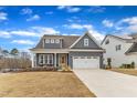 Charming two-story home with a two-car garage, quaint front porch, and an extended concrete driveway at 112 Sire Ct, Holly Springs, NC 27540