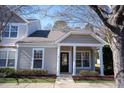 Inviting single story home with a covered front porch and a well-maintained lawn at 11327 Shadow Elms Ln, Raleigh, NC 27614