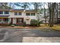 Charming two-story townhomes with green shutters, a well maintained lawn, and mature trees at 121 Westview Dr # 106, Carrboro, NC 27510