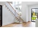 Bright foyer with hardwood floors, staircase, and natural light at 1421 Sky Vista Way, Raleigh, NC 27613