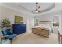 Spacious main bedroom with tray ceilings, generous natural light, and neutral carpeting at 1425 Princess Anne Rd, Cary, NC 27607