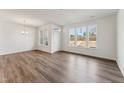 Spacious living room boasts large windows and wood-style flooring for a modern look at 1426 Cooper St, Sanford, NC 27330