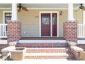 Inviting front porch with brick stairs and pillars, showcasing a welcoming entryway to the home at 1426 N Roxboro St, Durham, NC 27701