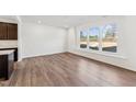 Bright living room featuring hardwood floors, large windows with backyard views, and an open concept design at 1430 Cooper St, Sanford, NC 27330