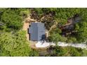 Aerial view of a home with a new roof surrounded by a lush, green landscape and mature trees at 149 Amber Rd, Timberlake, NC 27583