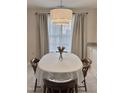 Bright breakfast nook featuring a round dining table with seating and natural light from the window at 1613 Bulon Dr, Cary, NC 27518