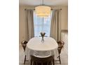 Dining area features an oval table, chandelier, and large window with curtains at 1613 Bulon Dr, Cary, NC 27518