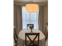 Inviting dining room with modern lighting fixture and a bright window view, perfect for Gathering meals at 1613 Bulon Dr, Cary, NC 27518