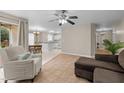 Open living area showcasing tile floors, a comfortable sofa, dining table, and bright kitchen at 1613 Bulon Dr, Cary, NC 27518