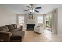 Cozy living room featuring a fireplace, comfortable seating, and natural light at 1613 Bulon Dr, Cary, NC 27518