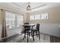 Bright dining area with large windows, modern lighting, and seating for a cozy meal at 204 Cassada Ct, Holly Springs, NC 27540