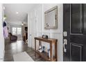 Stylish entryway with console table, mirror, and decorative details, leading into the living space at 204 Cassada Ct, Holly Springs, NC 27540