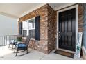 Inviting front porch with stone accents, seating, and a welcoming entrance to the home at 204 Cassada Ct, Holly Springs, NC 27540