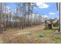 Expansive backyard with mature trees and a wooden deck, offering plenty of outdoor living space at 228 Sacred Fire Rd, Louisburg, NC 27549