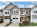 Inviting townhouse with a two-car garage, charming exterior and well-maintained landscaping at 2314 Wispy Green Ln, Raleigh, NC 27614
