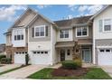 Attractive townhome featuring two-car garage, varied siding, and well-manicured landscaping at 2314 Wispy Green Ln, Raleigh, NC 27614