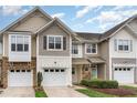 Charming townhouse featuring a mix of siding, stone accents, and a one-car garage, creating curb appeal at 2314 Wispy Green Ln, Raleigh, NC 27614