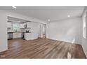 Bright living room features hardwood floors, white walls, and natural light from windows at 2506 Dominion St, Durham, NC 27704