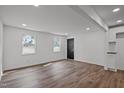 Open-concept living area with hardwood flooring, white walls, and modern lighting at 2506 Dominion St, Durham, NC 27704