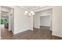 Open concept dining room with modern chandelier, hardwood floors, and access to kitchen at 269 Umstead St, Sanford, NC 27330