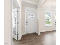 Bright entryway with hardwood floors, white trim, and glass paned french doors on left at 269 Umstead St, Sanford, NC 27330