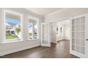 Sunlit living room showcasing wood floors, recessed lighting and ample windows, adjacent to french doors at 269 Umstead St, Sanford, NC 27330