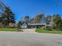Charming blue two-story home with well-manicured lawn, lovely landscaping, and a spacious driveway at 310 Electra Dr, Cary, NC 27513