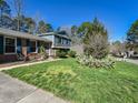 Charming two-story home featuring brick accents, blue shutters, and a well-manicured front lawn at 310 Electra Dr, Cary, NC 27513