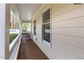 Relaxing front porch with wooden floors and white railings offering outdoor living space at 3101 Rutledge Ct, Raleigh, NC 27613