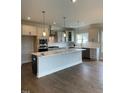 Spacious kitchen with gray cabinets, stainless steel appliances, and an oversized kitchen island at 321 Kavanaugh Rd, Wake Forest, NC 27587