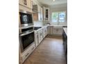 Beautiful kitchen showcasing stainless steel appliances, a farmhouse sink, and ample cabinet space at 321 Kavanaugh Rd, Wake Forest, NC 27587