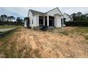 View of the home's exterior shows white siding, nice columns, and a covered porch area at 3405 Makers Circle, Raleigh, NC 27612