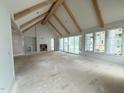 Large living room with beam ceiling, fireplace, built-in shelves, and sliding glass doors to the backyard at 3405 Makers Circle, Raleigh, NC 27612