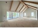 Spacious living room with vaulted ceilings, exposed wooden beams, and sliding glass doors to the outside at 3405 Makers Circle, Raleigh, NC 27612