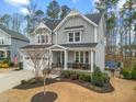 Stylish gray two-story home boasts a covered front porch, manicured lawn, and welcoming curb appeal at 3548 Willow Green Dr, Apex, NC 27502