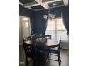 Open dining room featuring a round table illuminated by a modern chandelier and natural light at 433 Falling Brook Dr, Kenly, NC 27542