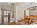 Inviting dining room features hardwood floors, traditional rug, and modern light fixture at 501 Nantucket Dr, Cary, NC 27513