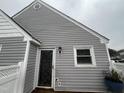 Close-up of the front door and window of this townhome, featuring neutral siding at 5054 Avenida Del Sol Dr, Raleigh, NC 27616