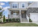 Inviting front porch with stone accents, white railings, and well-maintained landscaping at 5072 Aspen Meadow St, Raleigh, NC 27616