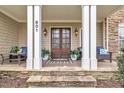 Inviting front porch with seating, stone accents, and a double-door entryway at 601 Ballad Creek Ct, Cary, NC 27519