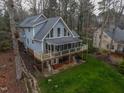 Beautiful lake house with a screened porch, open patio, and landscaped surroundings at 651 Sagamore Dr, Louisburg, NC 27549