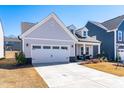 Stylish single-Gathering home showcasing a well-kept lawn and a convenient two-car garage at 74 Silver Moon Ln, Clayton, NC 27527