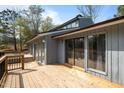 Wooden deck with view of exterior of the home showcasing gray siding and sliding glass doors at 75 Traceway N, Sanford, NC 27332